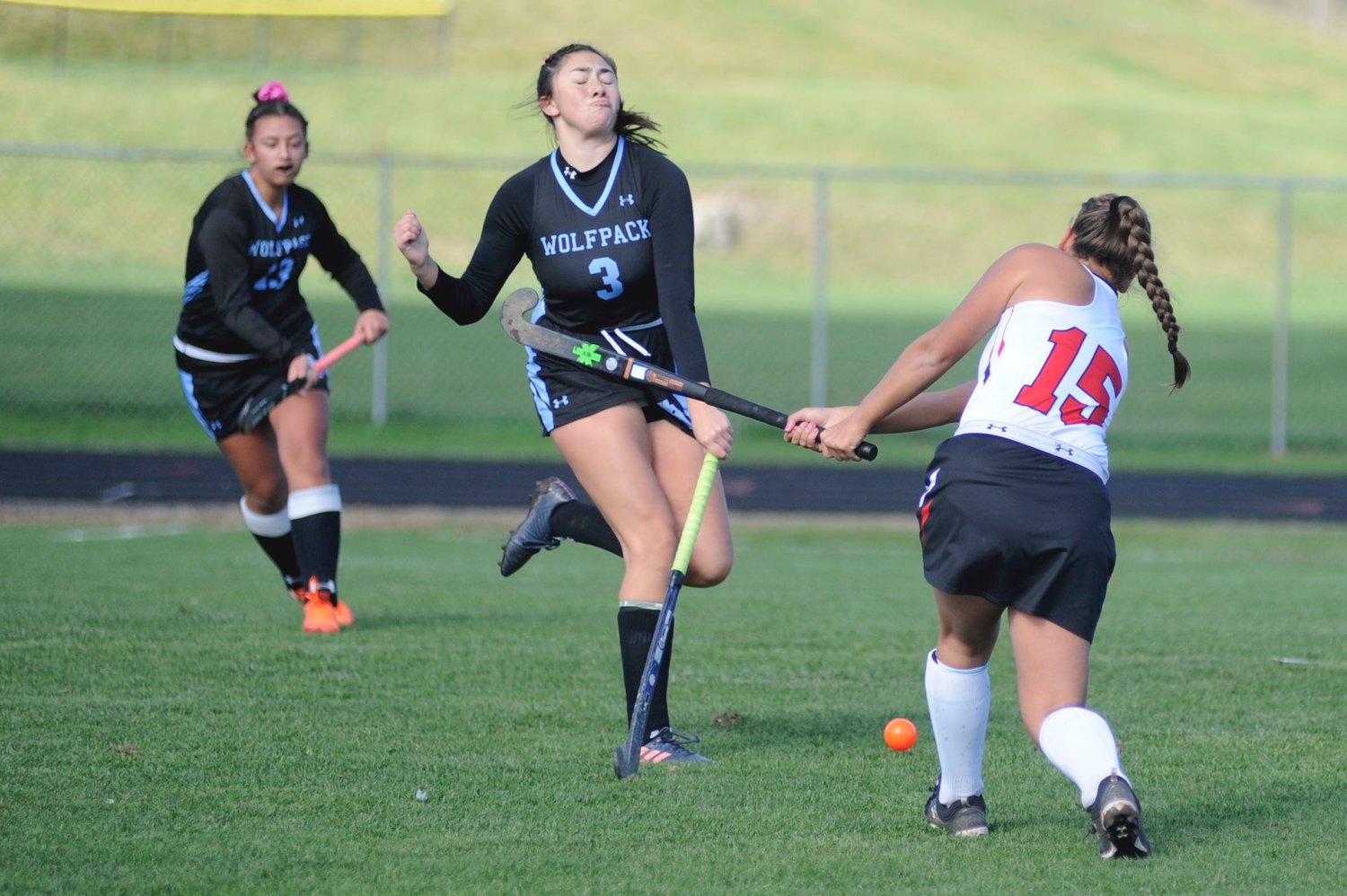 Wilkes Barre defender Candaladia Washinski reacts as Honesdale’s Gina Dell’Aquila drives the ball upfield. Mikayla Faatz of the Wolfpack closes in on the action.